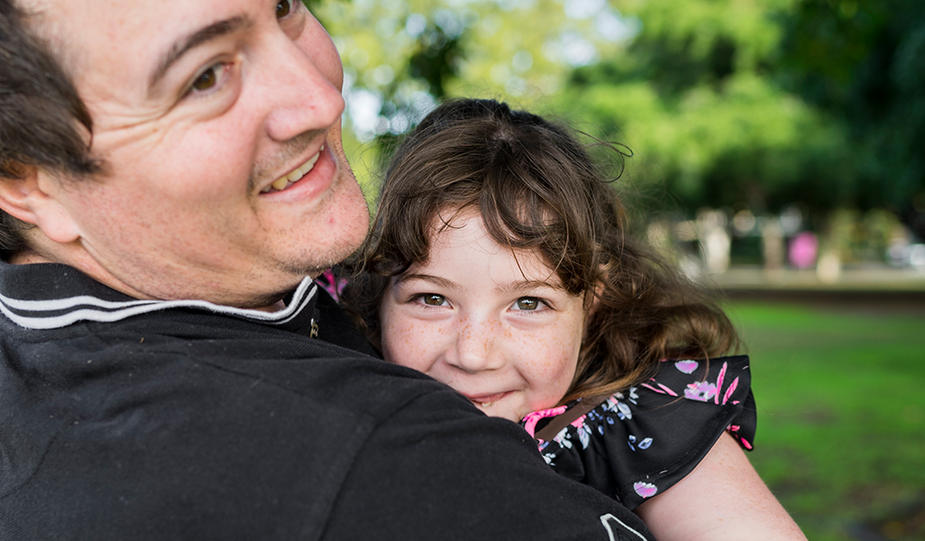 Father and daughter smiling